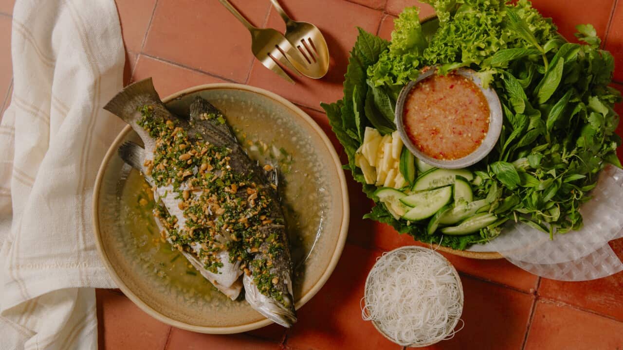 Vietnamese steamed whole fish in rice paper and herbs
