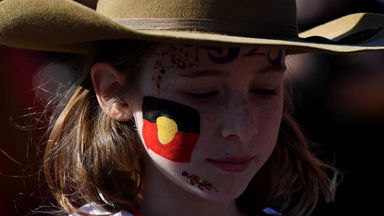 A supporter is seen with the Aboriginal flag painted on her face during a Yes 23 community event in support of an Indigenous Voice to Parliament, in Sydney, Sunday, July 2, 2023.
