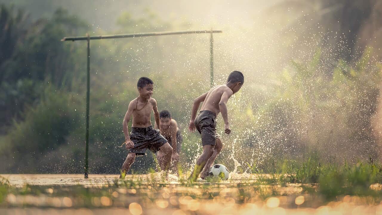 Children playing football in Thailand - Pixabay