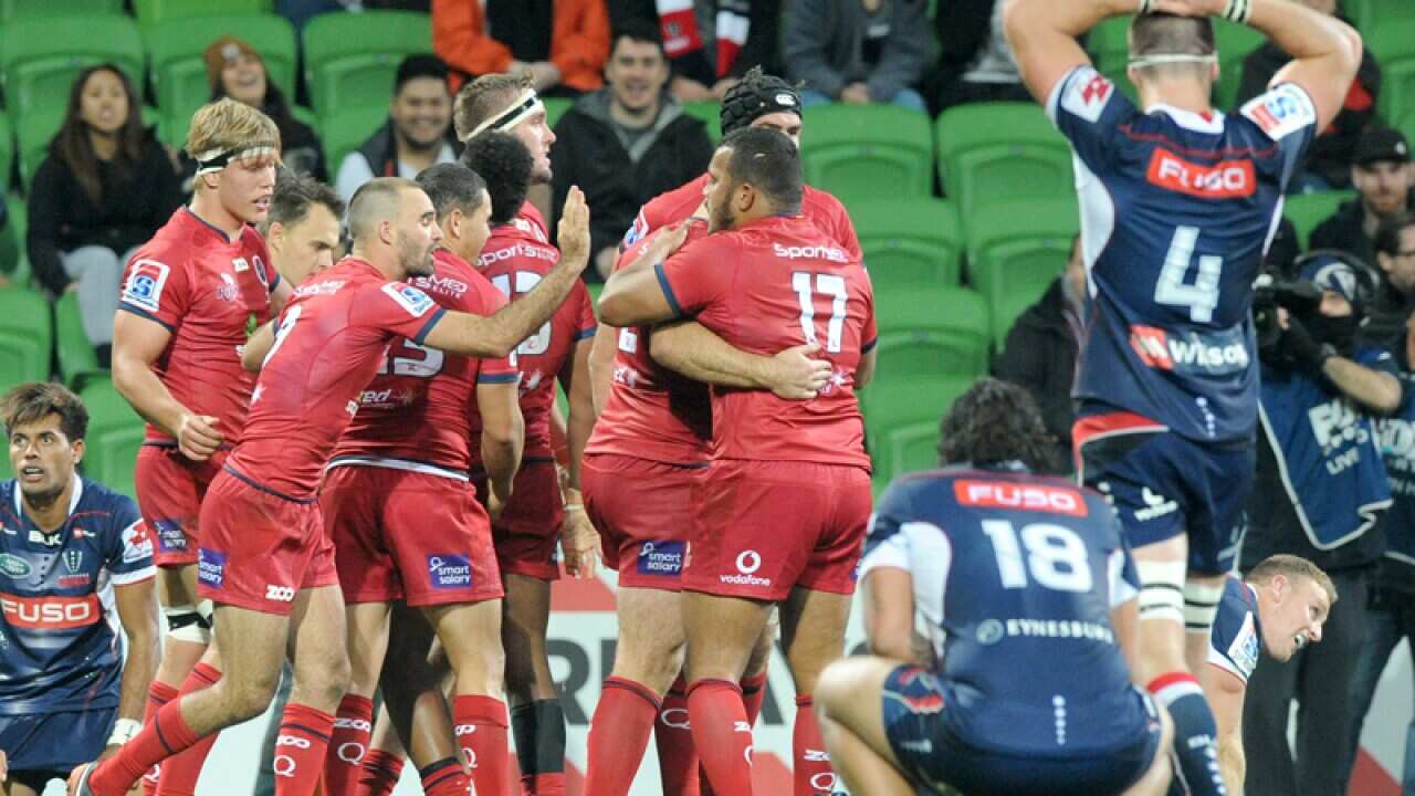 Samu Kerevi of the Reds is congratulated after scoring