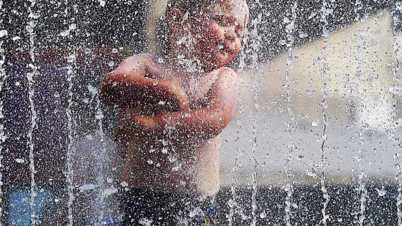 A child enjoys a cool fountain