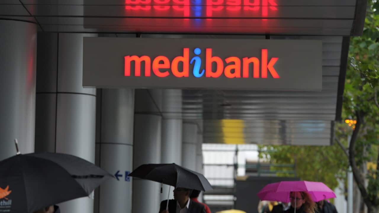 Pedestrians walk past the Medibank Docklands branch in Melbourne