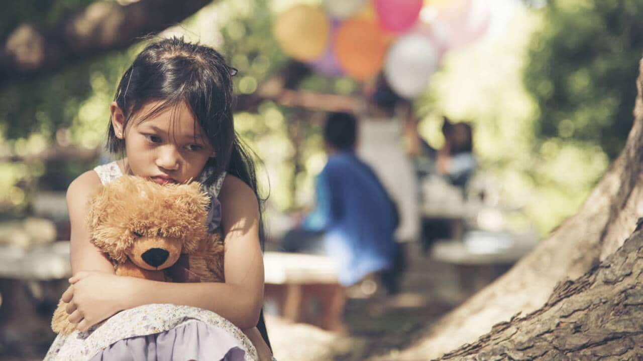 Sad girl feeling alone in the park concept.Lonely beautiful toddler girl stay alone in the park.