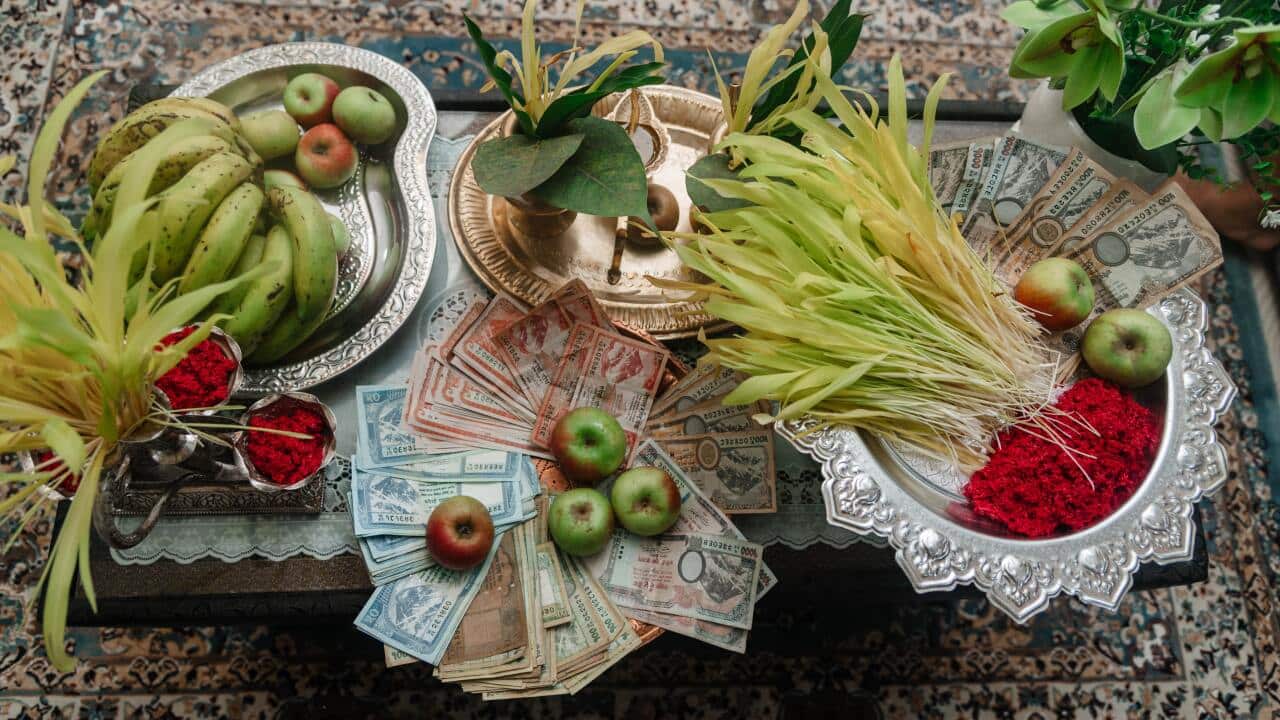 Dashain preparations with 'tika', 'jamara', cash and fruits.