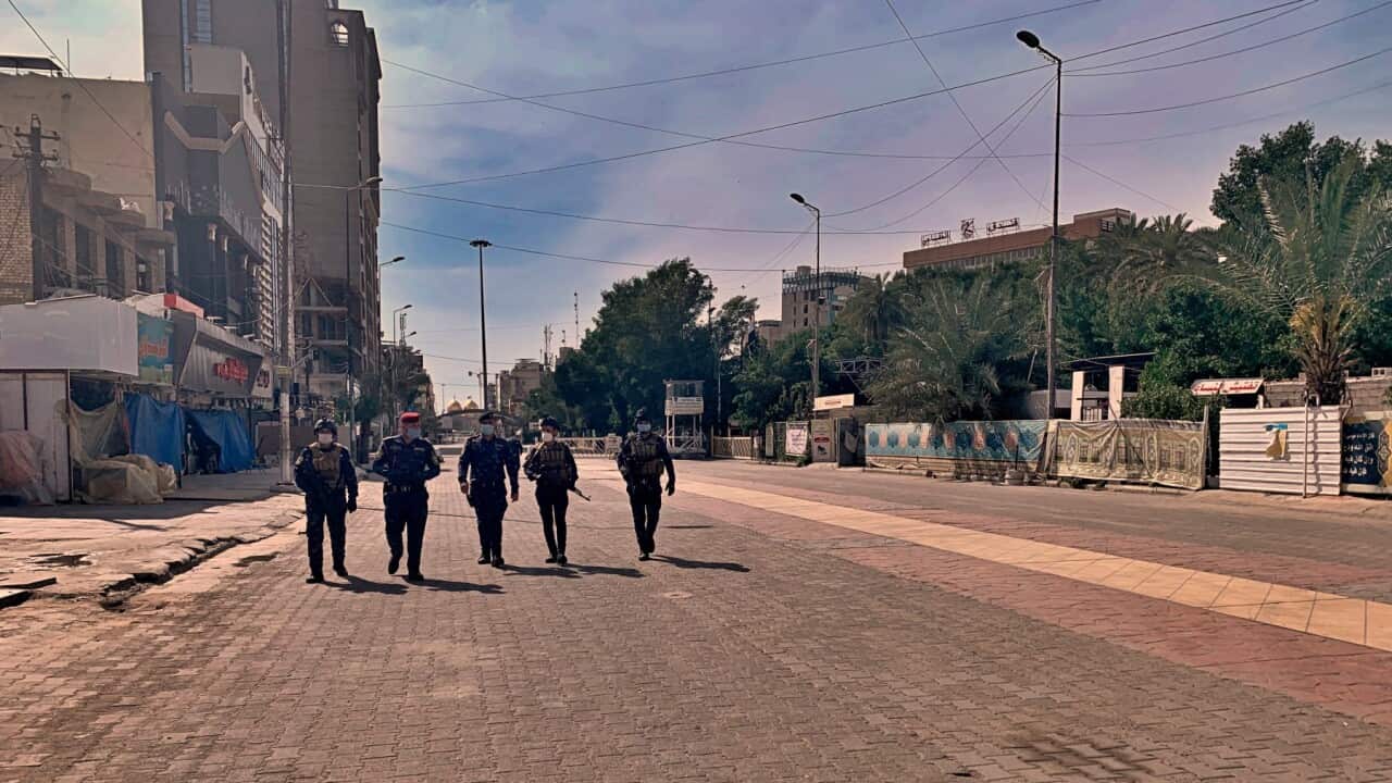 Iraqi security forces patrol to enforce a curfew to help fight the spread of the coronavirus