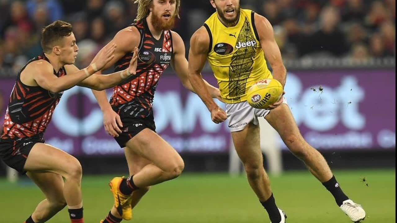 Shane Edwards of the Tigers (r) is seen in action against Essendon.