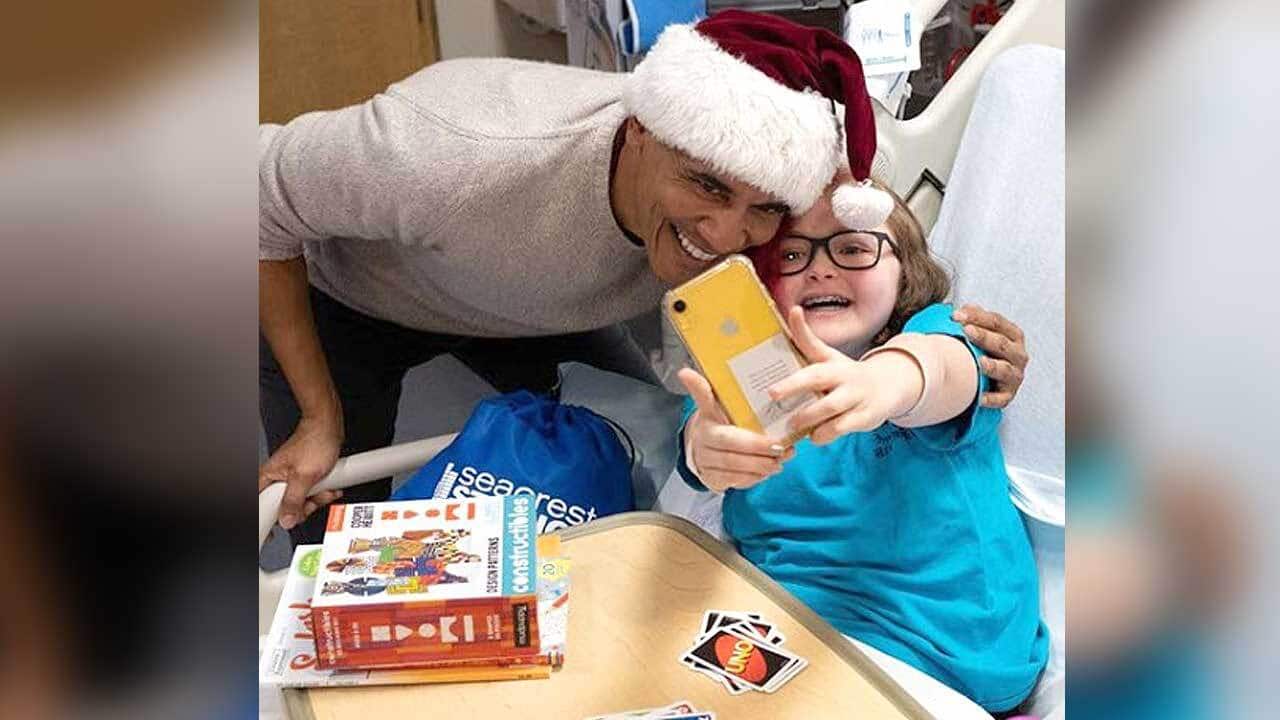 Former US President Barack Obama dons a Santa hat to spread Christmas cheer - and selfies - to the children at the Childrens National Medical Centre.