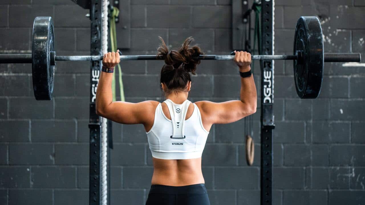 Woman lists weights, Gyms are opening up across the country, are you ready to exercise?
