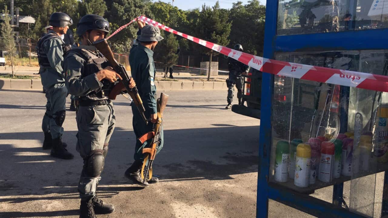 Security officials inspect the scene of a bomb blast in Kabul