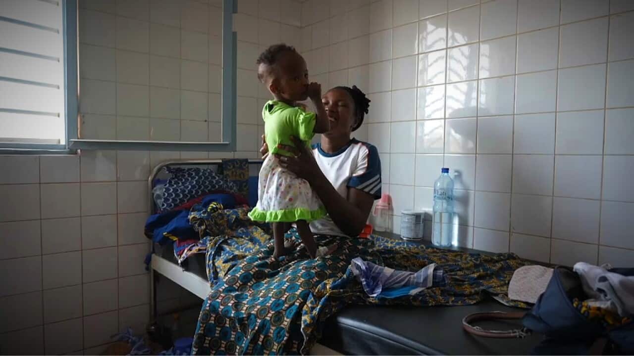 Martine Roamba with her 10-month-old malnourished daughter (AP).jpg