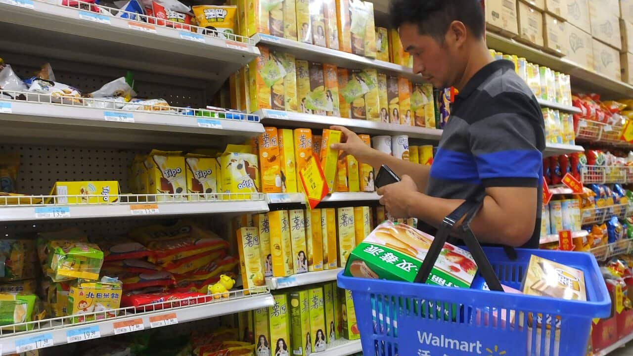 A customer shops at a supermarket in Yichang city, central China's Hubei province, August 2016.