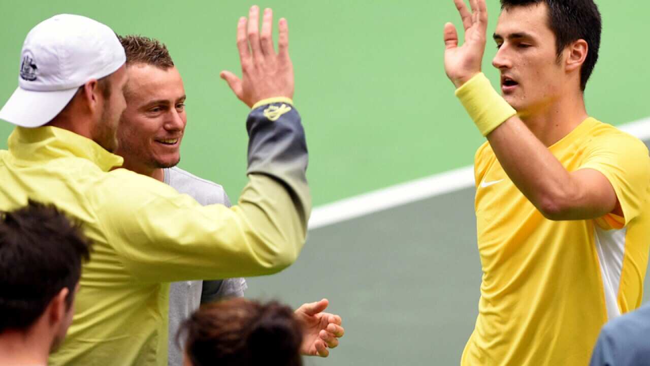 Bernard Tomic (L) celebrates with his Davis Cup teammates