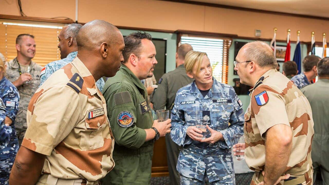 Air Command Warrant Officer, Warrant Officer Fiona Grasby (centre), talks with senior enlisted personnel from the participating nations (RAAF).jpg