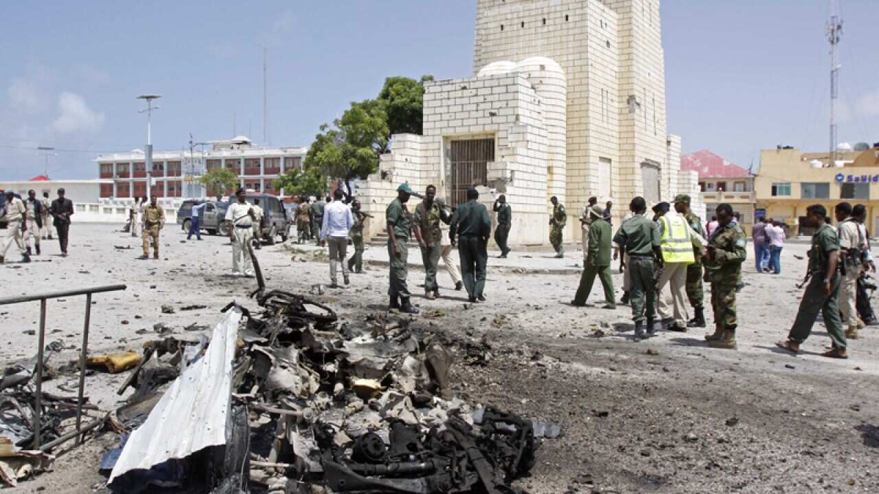 Soldiers at the wreckage of a car bomb near the Somali parliament