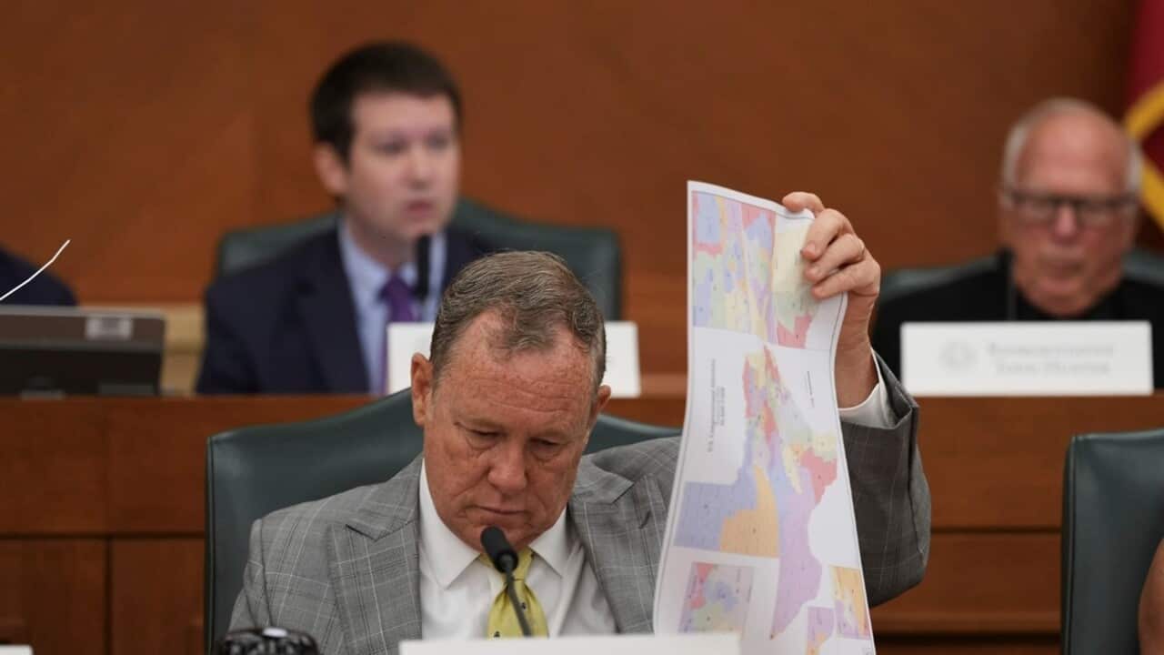Texas state Rep. Terry M. Wilson looks through maps during a public hearing on congressional redistricting in Austin, Texas (AAP).jpg