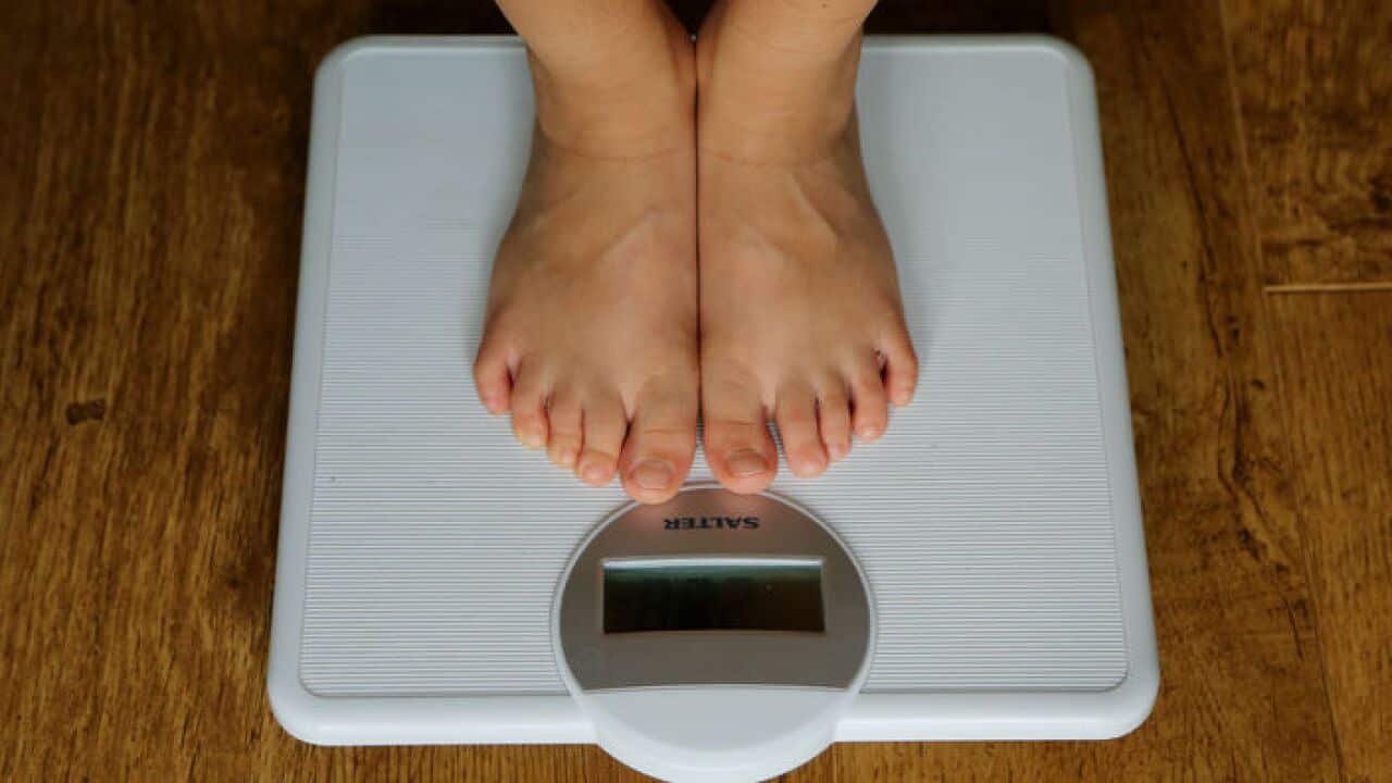 A child checking the scales (AAP)