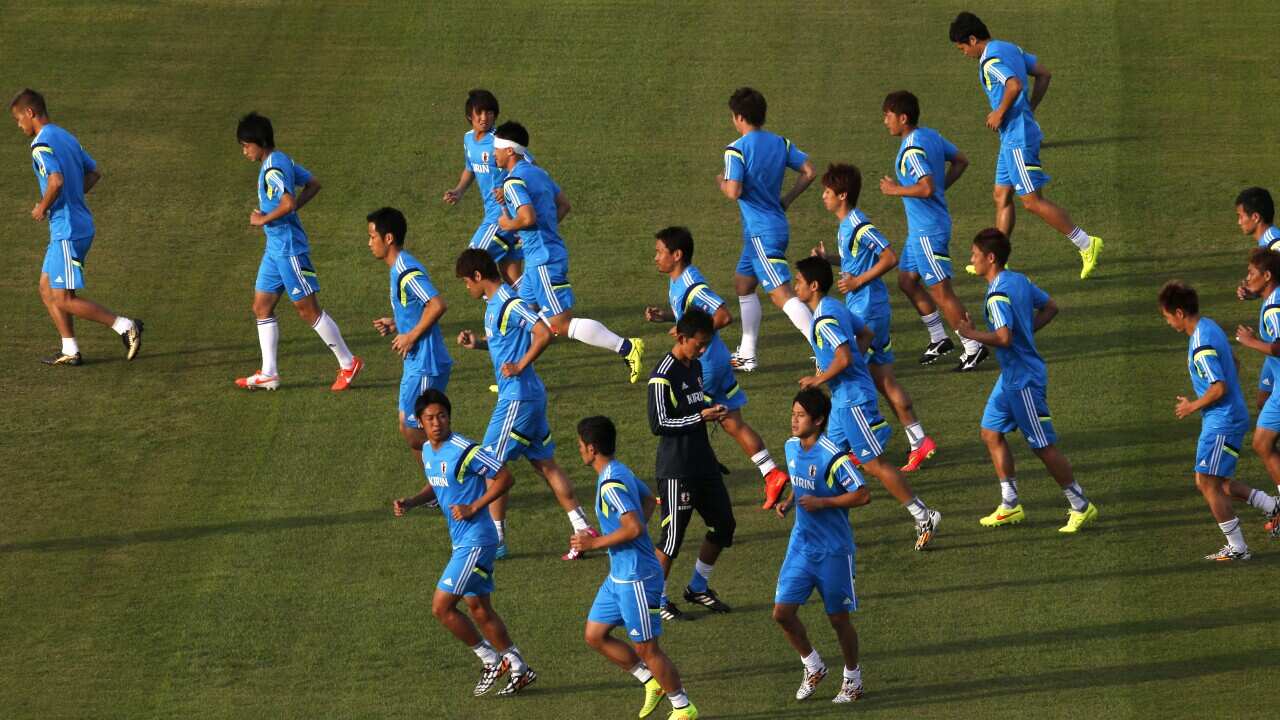 Japanese soccer team players warm up during a training session of Japan in Sorocaba, Brazil, Sunday, June 8, 2014. (AAP)