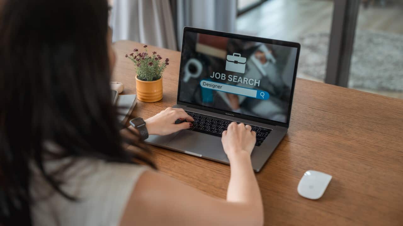 Close-up shot of woman looking at online job search website on her laptop