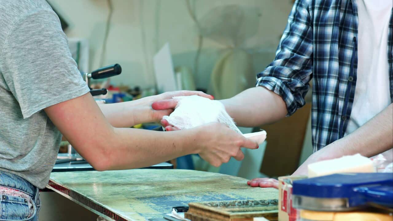 female-hands-carefully-bandaging-worker-injured-hand-after-accident-SBI-351443310.jpg