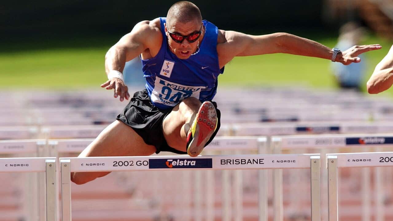 Brisbane, April 14, 2002. Kyle Vander Kuyp during the final of the mens 110m hurdles at the Australian Track and Field Championships in Brisbane today. (AAP Image/Dave Hunt) NO ARCHIVING.