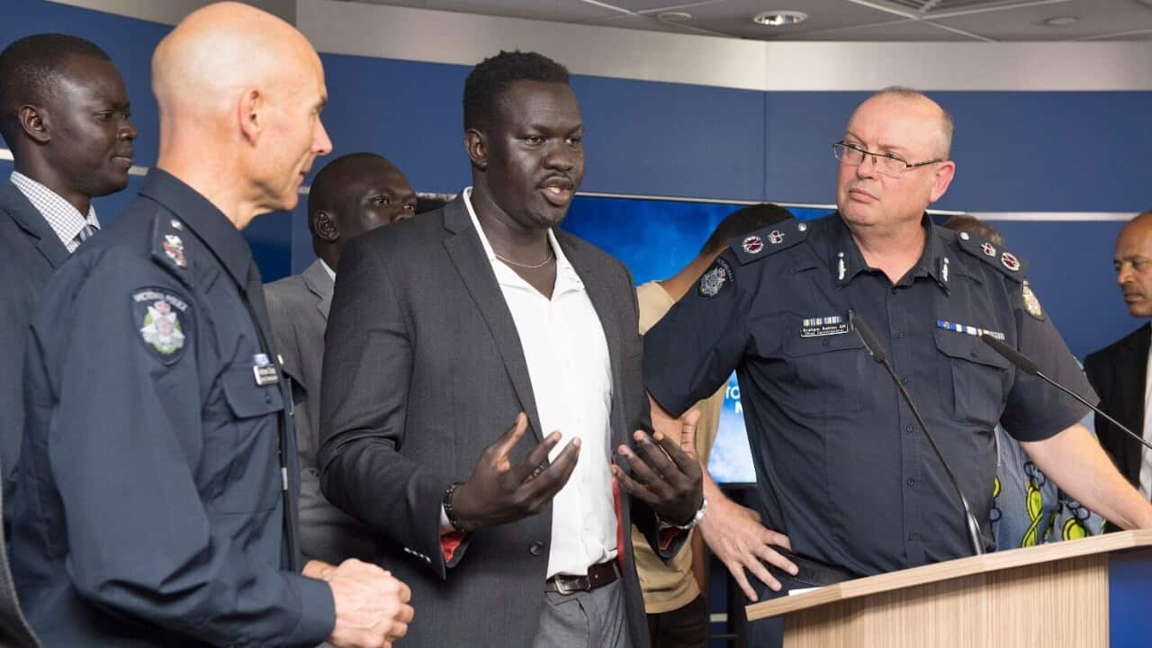 Victorian Deputy Commissioner Andrew Crisp (left) and Chief Police Commissioner Graham Ashton listen as African community leader John Kuot