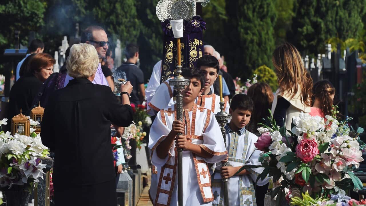 Altar boys lead the Epitaphio (the symbolic funeral bier of Christ) during a Good Friday service at Greek Orthodox Church of St. Athanasios at Rookwood Cemetery in Sydney, Friday, April 10, 2015