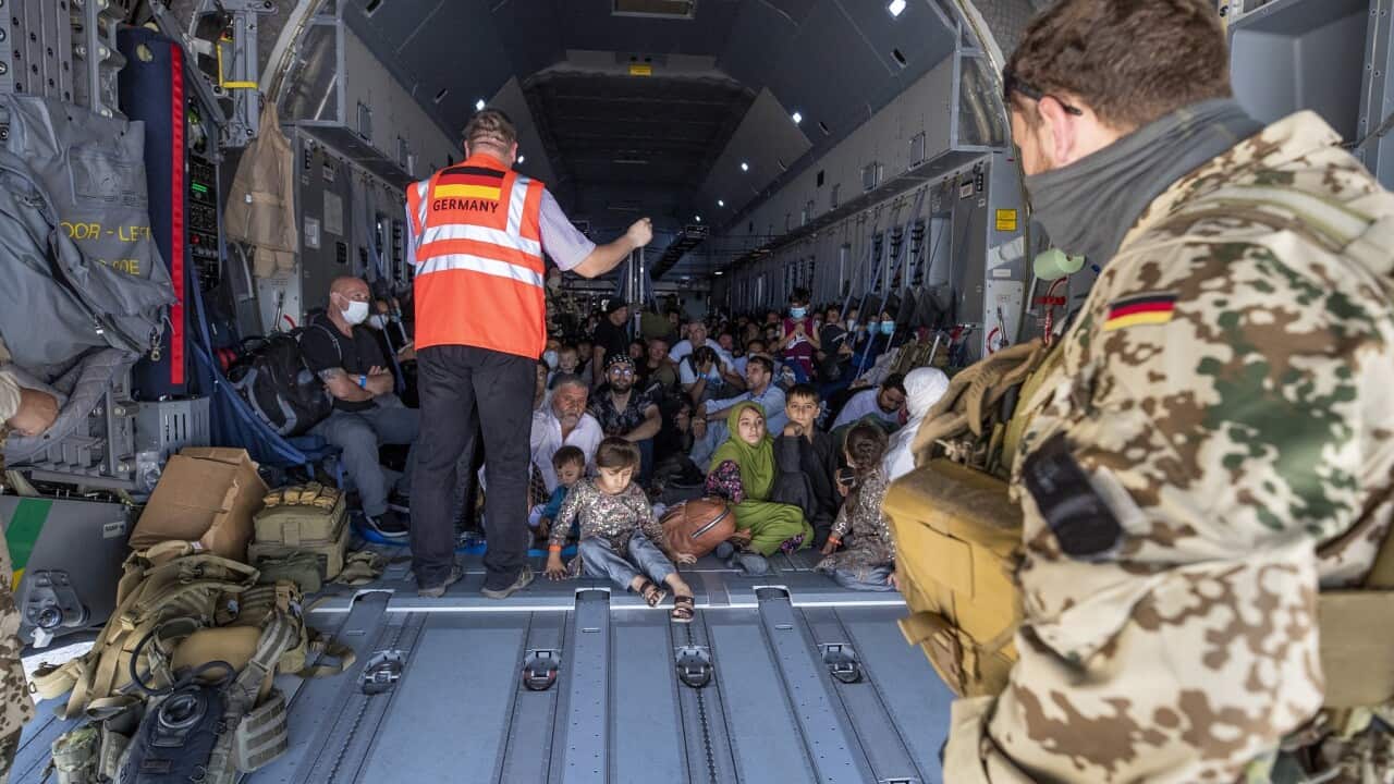 A handout photo made available by the German armed forces shows a staff member briefing evacuees from Afghanistan upon arrival from Kabul onboard an A400 transport aircraft of the German Air Force at Tashkent airport, Uzbekistan, 18 August 2021. EPA/BUNDE