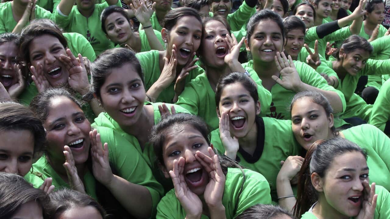 Students cheer as they take part in "One Billion Rising" campaign in a street in Chandigarh, India.