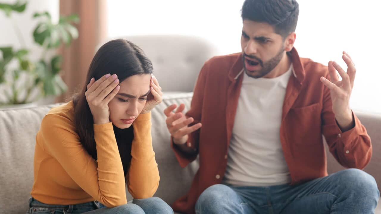Angry Muslim Husband Yelling Wife Sitting On Sofa At Home