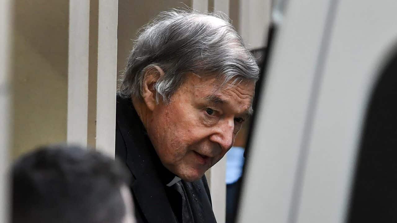 Australian Cardinal George Pell (C) is escorted in handcuffs from the Supreme Court of Victoria in Melbourne.
