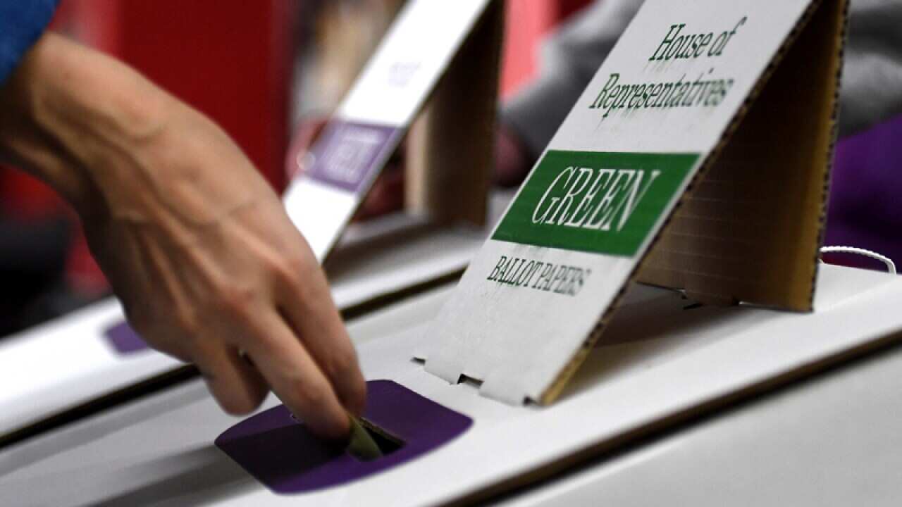 Voters cast their ballot in the federal election