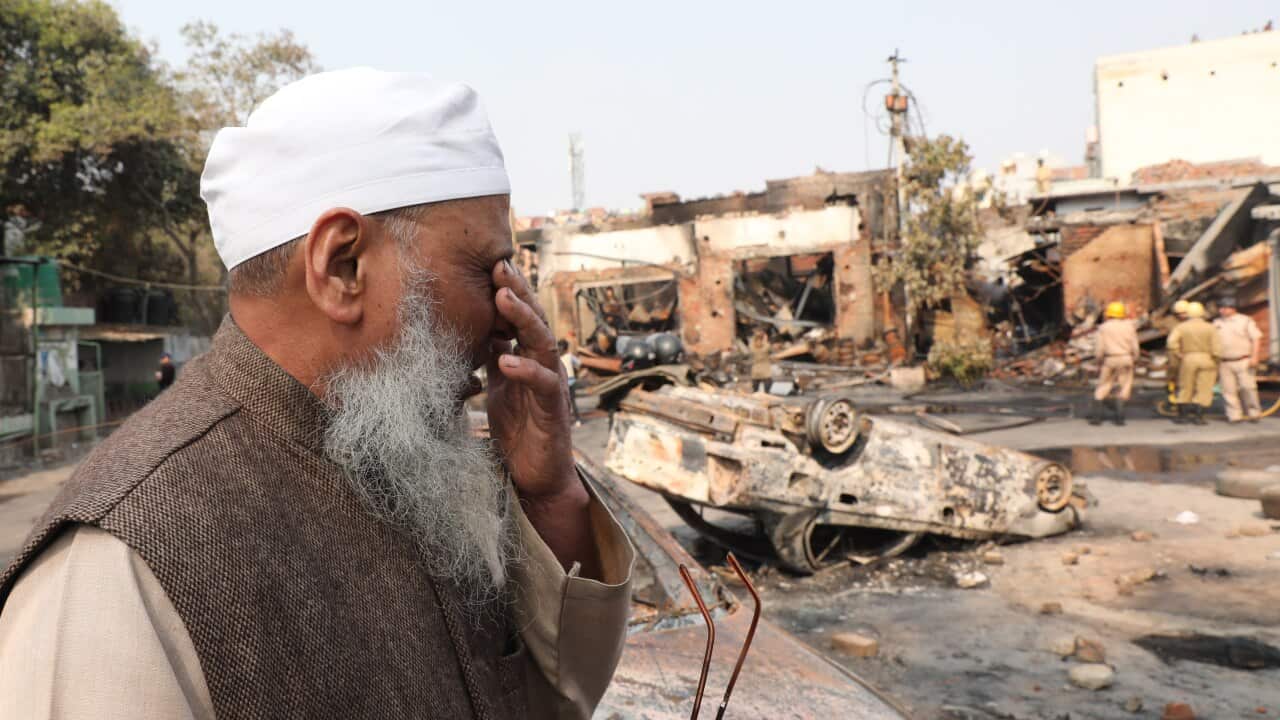 Indian Muslim man Abdul Hafiz looks at the burnt market near Gokulpuri metro station after clashes in New Delhi, India.