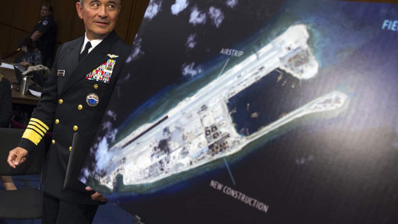 US Navy Commander Harry B. Harris with a map of a Chinese island