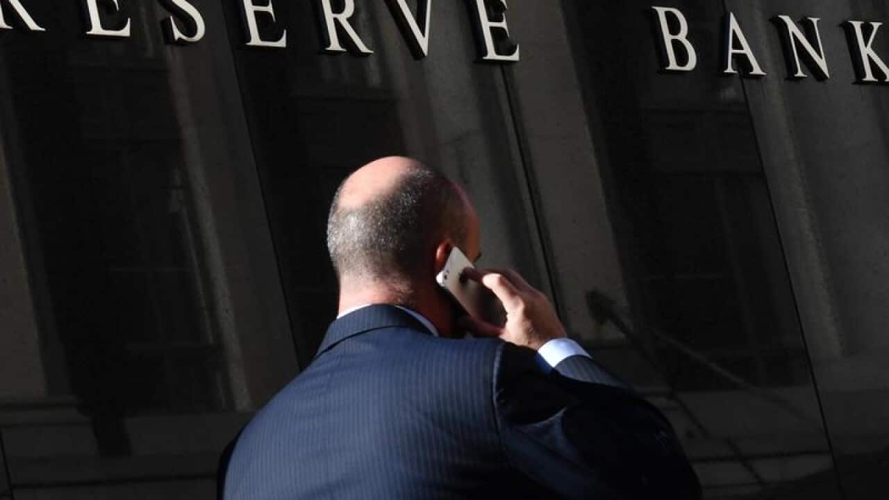 A pedestrian walks past the Reserve Bank