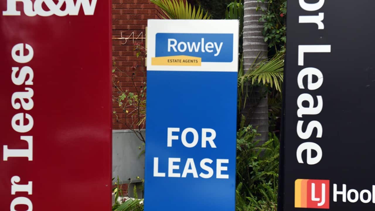 For Lease signs outside a block of units