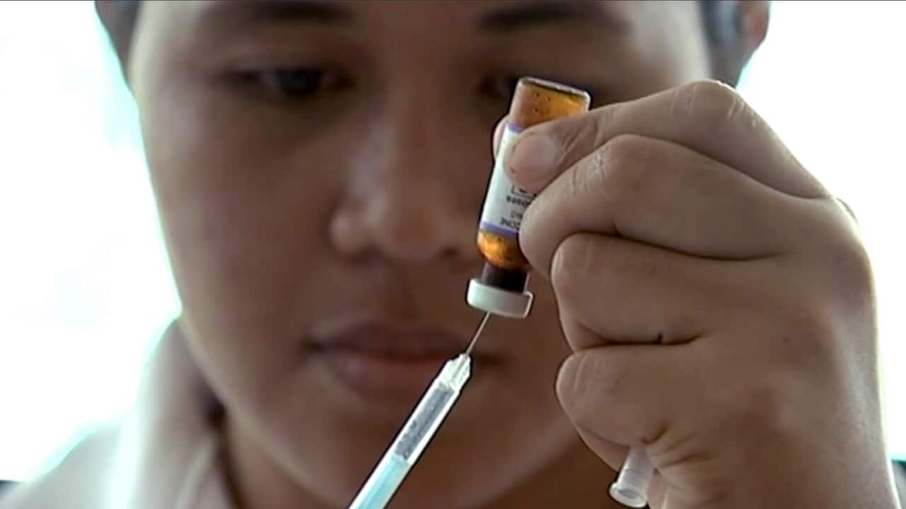 A New Zealand health official prepares a measles vaccination at a clinic in Apia, Samoa