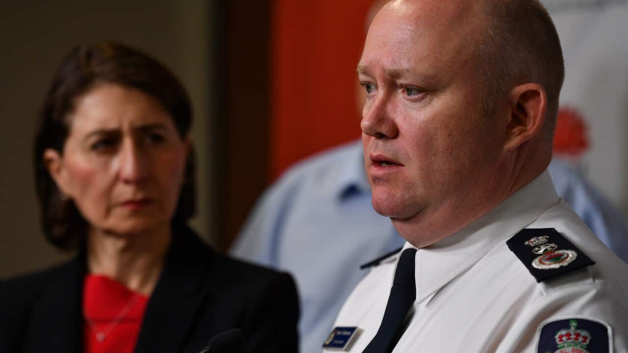 NSW Premier Gladys Berejiklian looks on as RFS Commissioner Shane Fitzsimmons speaks to the media during a press conference in Sydney, 5 January 2020.