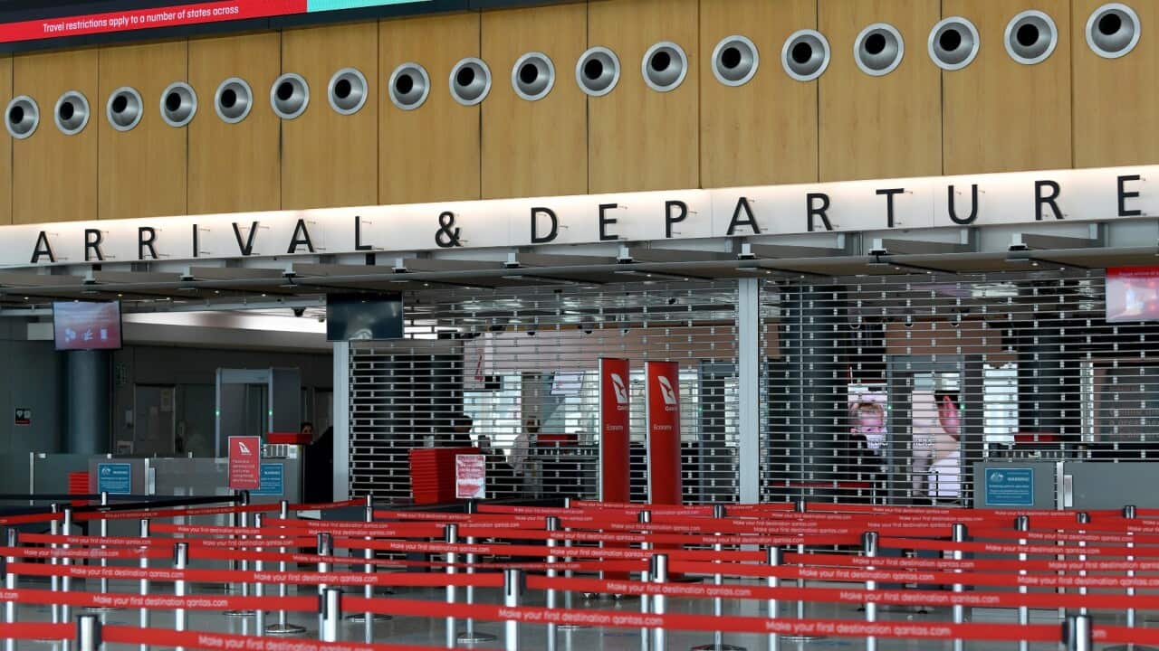 Qantas will cut at least 6,000 jobs. An empty arrivals and departures security point at the Qantas terminal at Sydney Airport.