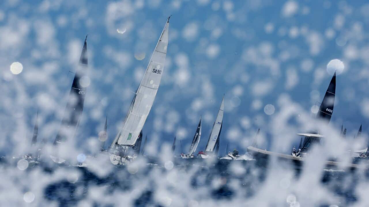 Yachts sails south out of the Sydney Heads during the 2022 Sydney to Hobart yacht race on Boxing Day.