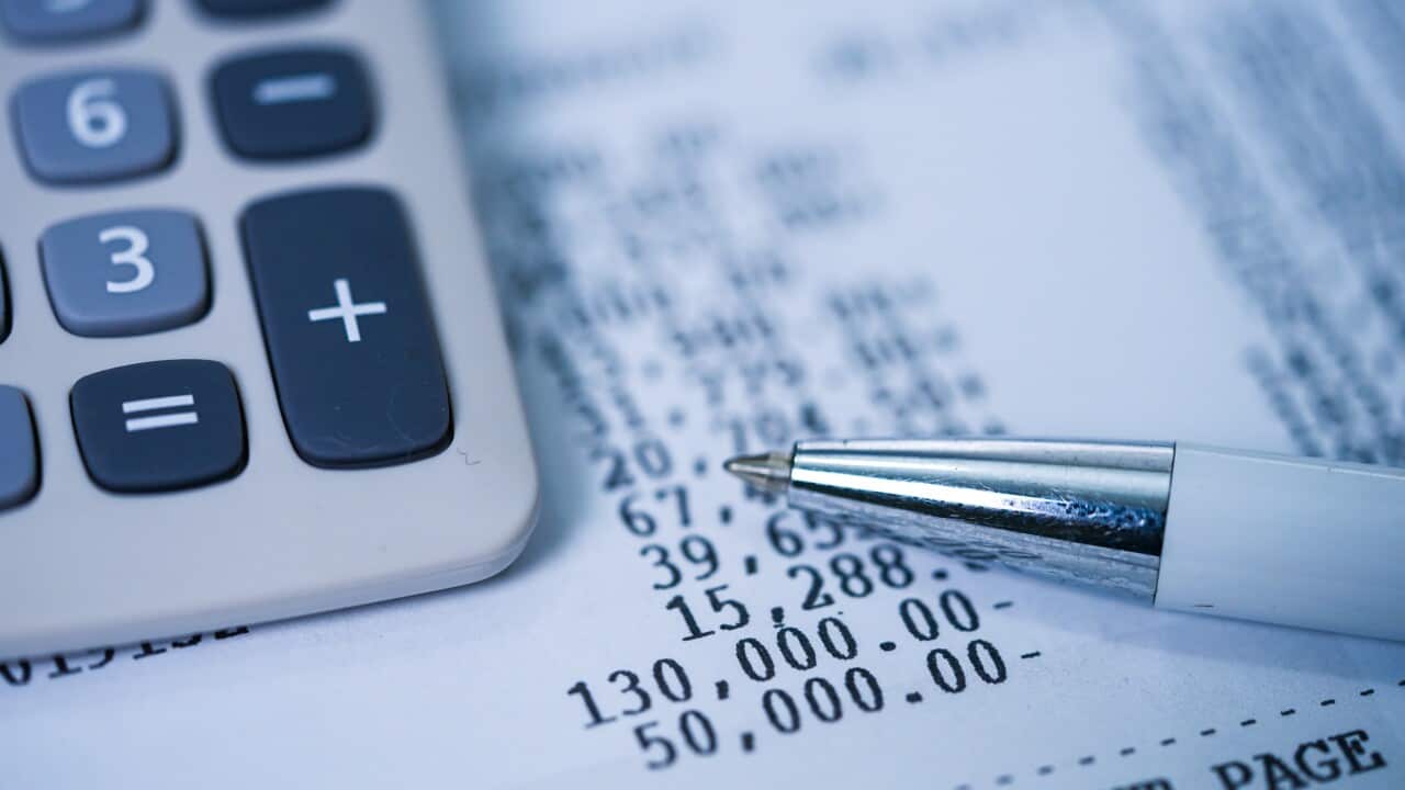 A calculator, pen and a bank statement.