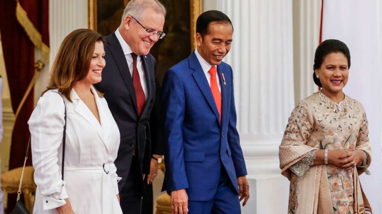 Australian Prime Minister Scott Morrison and Indonesian President Joko Widodo, accompanied by their wives, meet at the presidential palace in Jakarta.