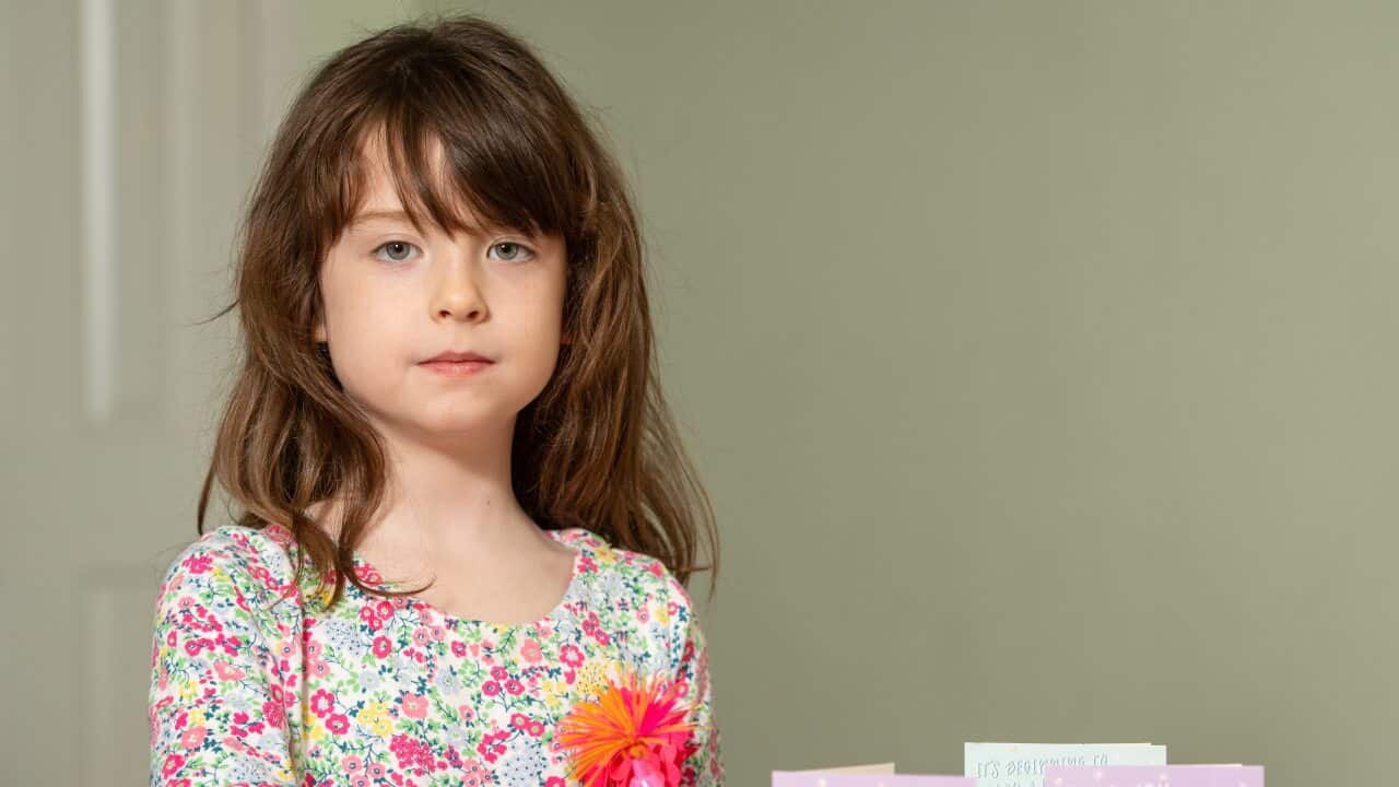 Florence Widdicombe, 6, writing in a Tesco Christmas card from the same pack as a card she found contained a message from a Chinese prisoner.
