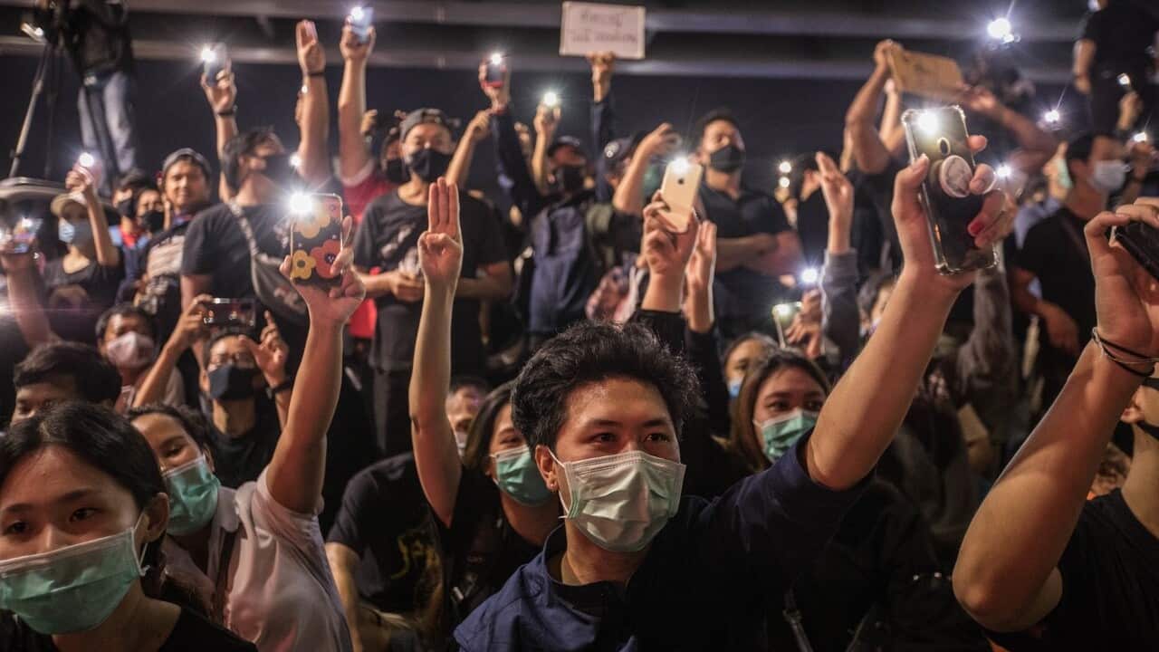 thumbnail_Pro-democracy protesters seen holding their phones during an anti-government demonstration in Bangkok. (AAP)