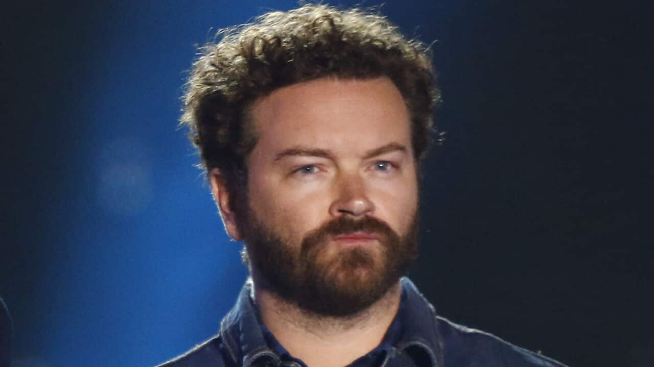 A man in a blue collared shirt