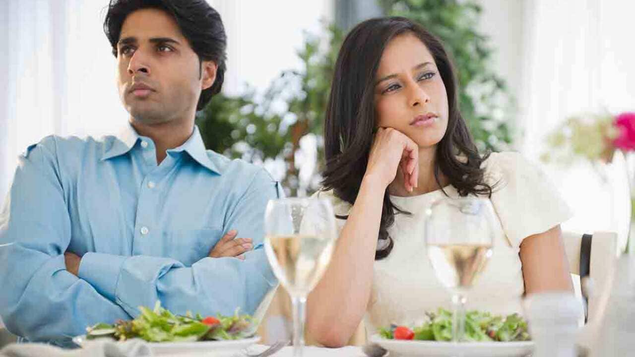 Couple arguing at dinner table