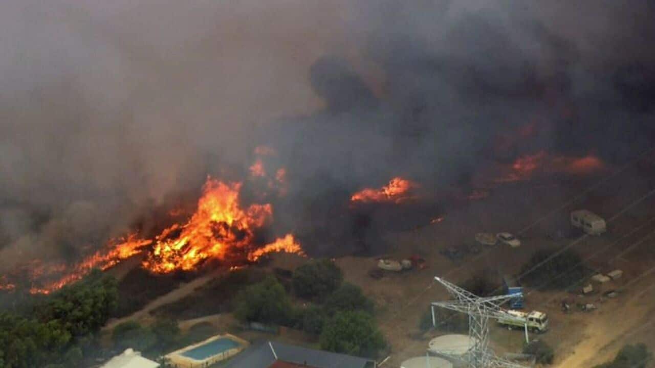 The fast-moving fire is threatening homes in Perth's southeast. 