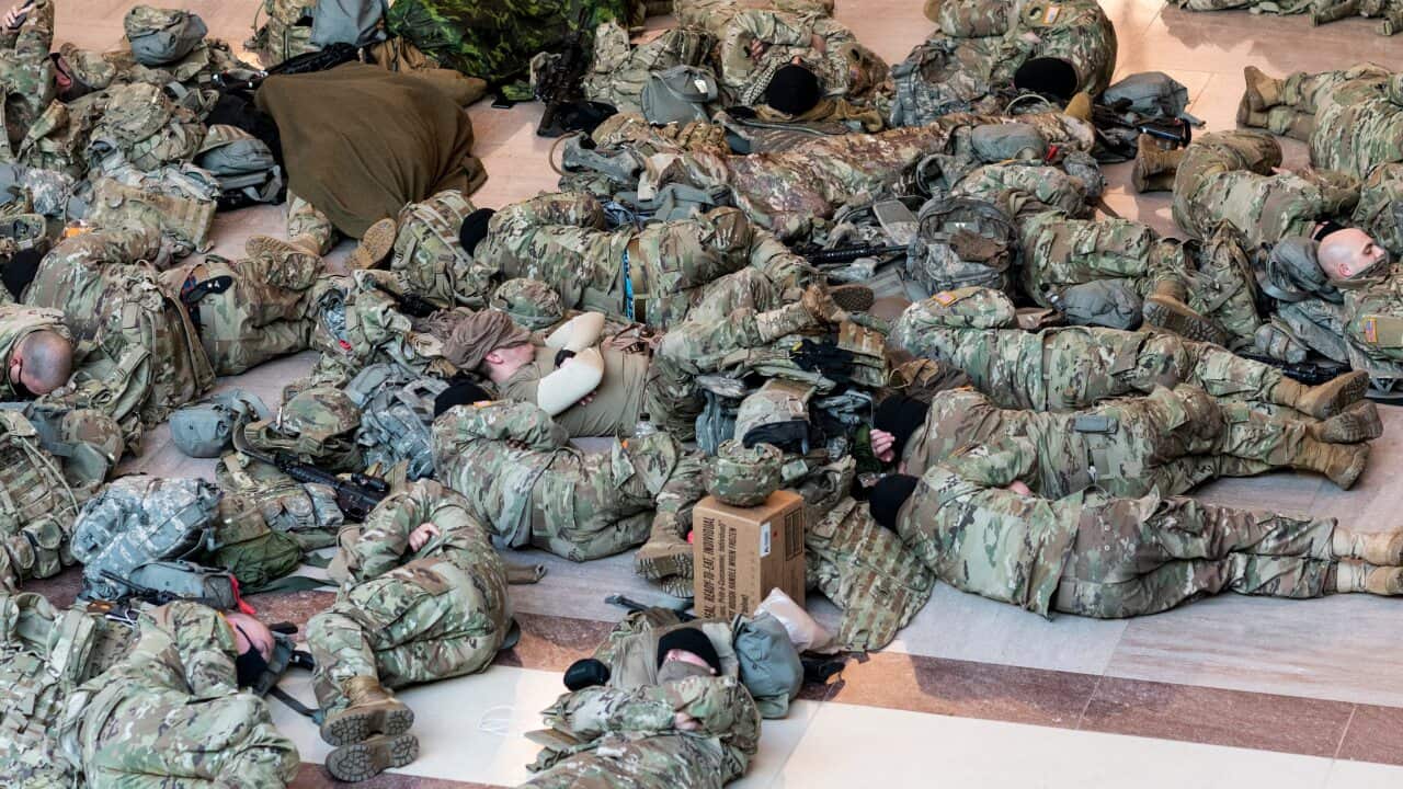 National Guard soldiers have been photographed sleeping in the Capitol building ahead of a House vote to impeach Donald Trump.