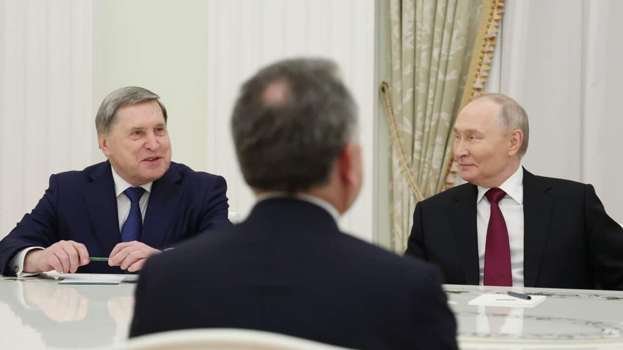 Three men sitting at a negotiation table including Vladimir Putin