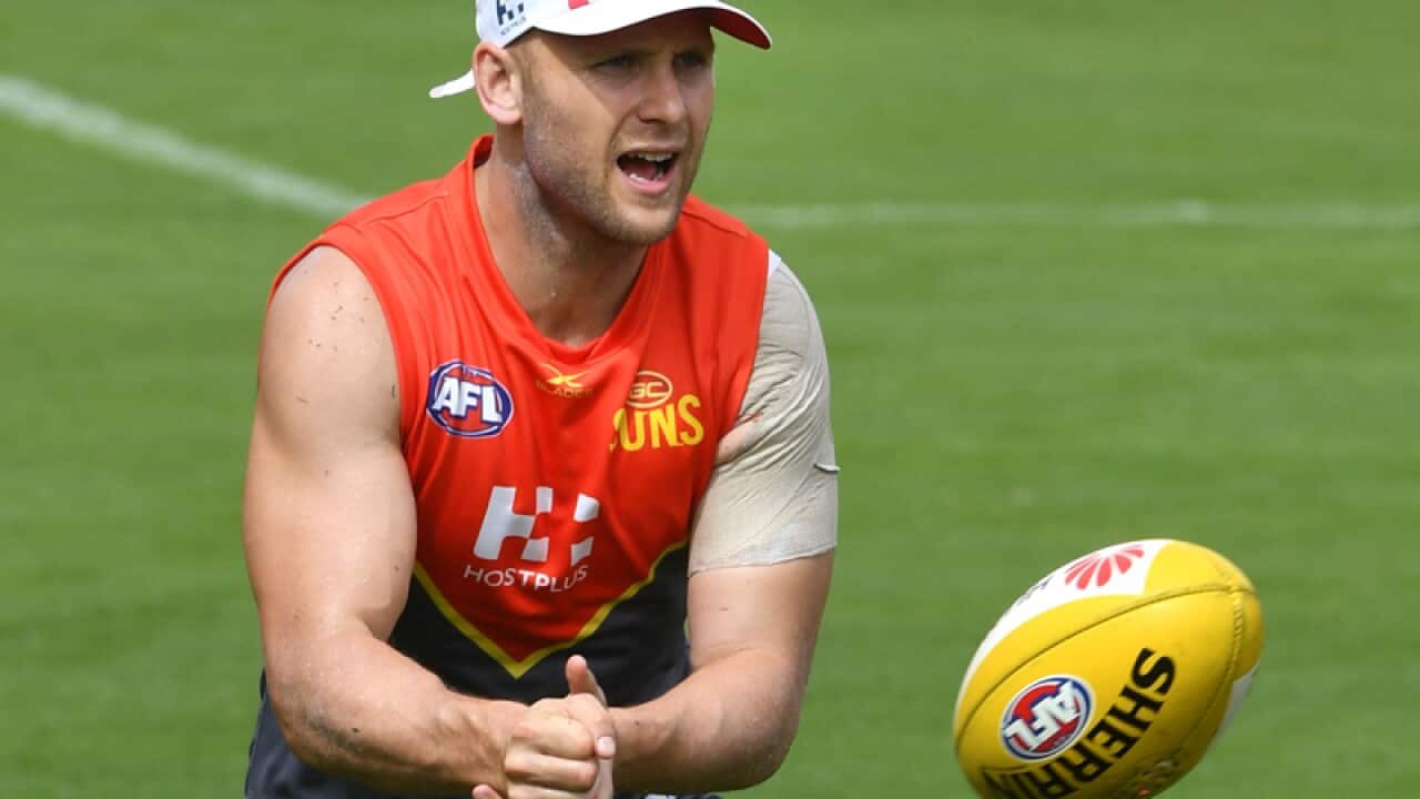 Gary Ablett handballs during a Gold Coast Suns training session