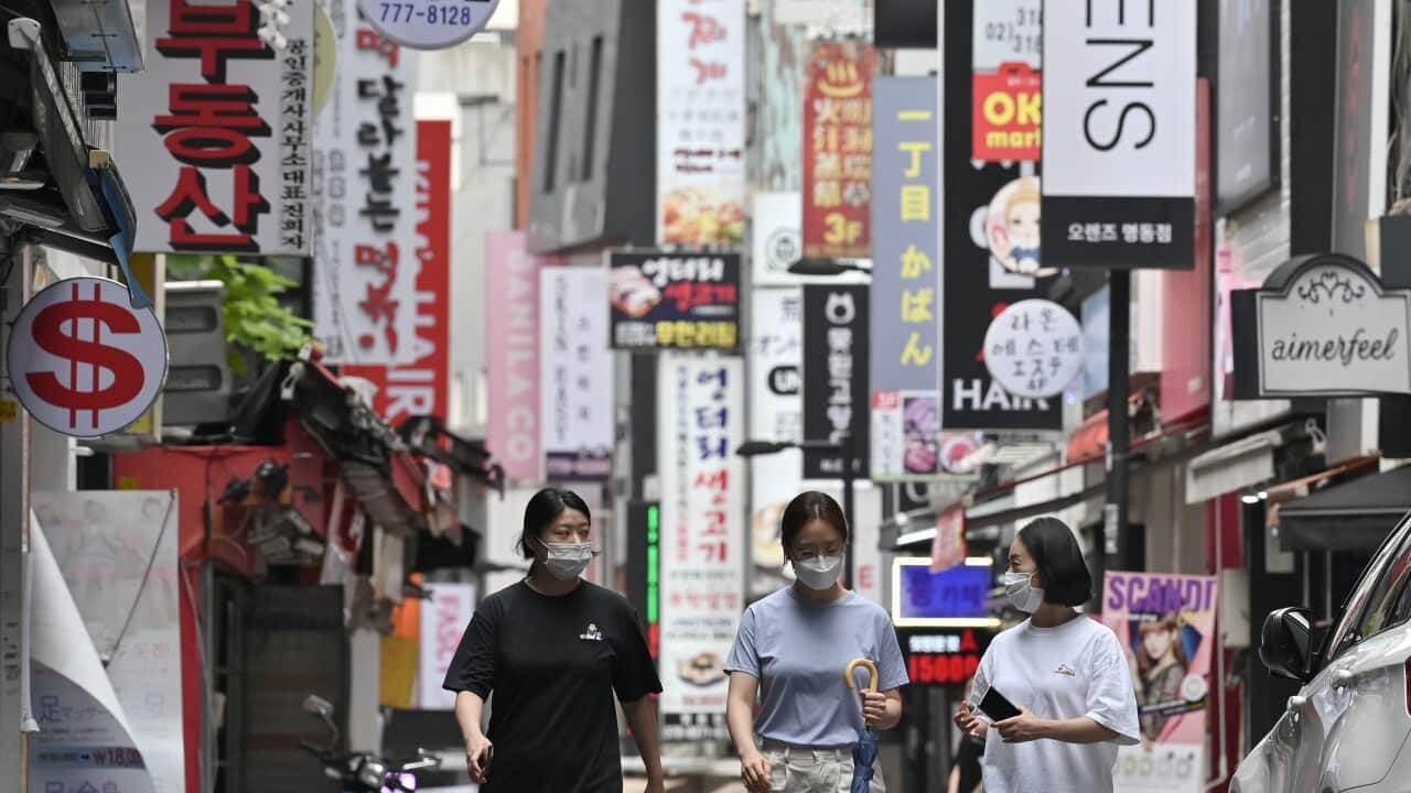 People walk through the Myeongdong shopping district in Seoul on August 27, 2020.